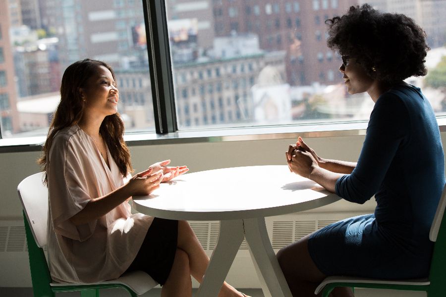 Two colleagues talking by a window